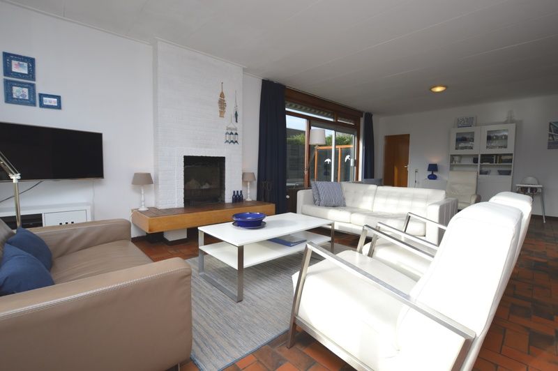 Cozy living room in Orchismient 18 large, De Koog, Texel with modern furnishings and fireplace.