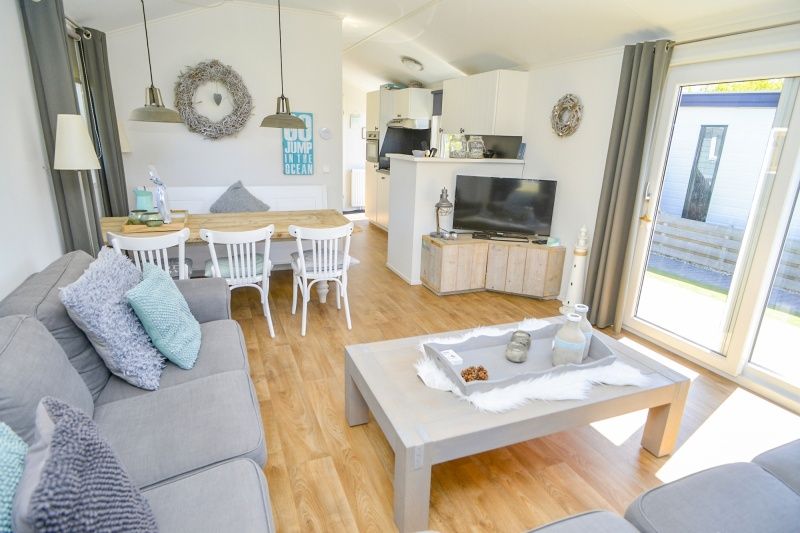 Lichte binnenruimte van Chalet Bregkoog 215 Zandhuisjes op Chaletpark Bregkoog, De Koog, Texel met open keuken en eetgedeelte.