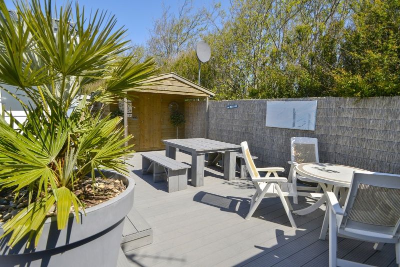 Zonnig terras van Chalet Bregkoog 215 Zandhuisjes, Chaletpark Bregkoog, De Koog, Texel met tuinmeubilair en privacy.