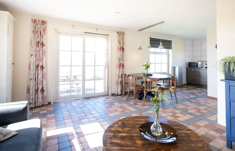 Cozy living room in Cottage in De Waal, Texel with lots of light and access to terrace.