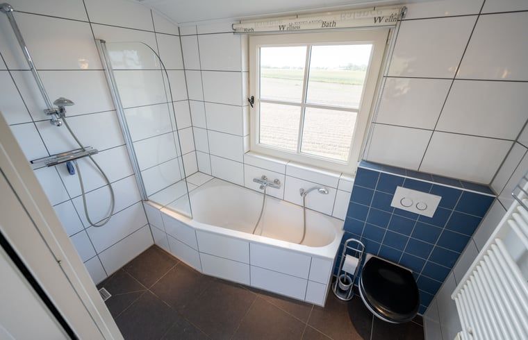 Modern bathroom with bathtub in vacation home Huisje in De Waal, Texel on the Wadden Islands.