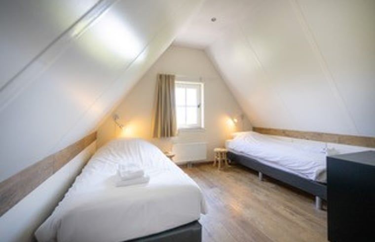 Attractive bedroom with two beds in Cottage in De Waal, Texel in the Wadden Islands.
