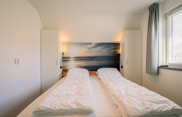 Bedroom with double bed in Holiday home in De Waal, Texel, restful and comfortable.