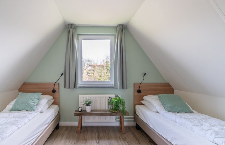 Cozy bedroom with single beds in Holiday cottage in De Waal, Texel, ideal for children.