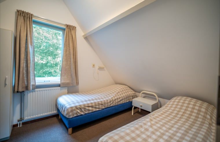 Tweede slaapkamer in Huisje in De Waal, Texel met knusse inrichting en uitzicht op de natuur.