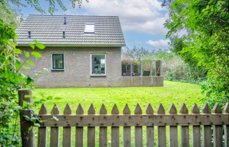 Achtertuin van Huisje in De Waal, Texel met omheining en veel privacy, perfect voor ontspanning.