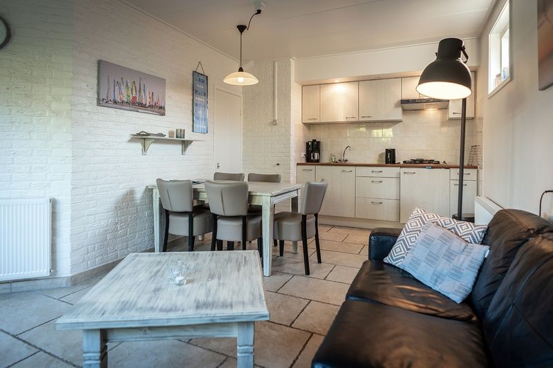 Cozy living space in Holiday Home De Heggemus, Den Burg, Texel with modern kitchen.