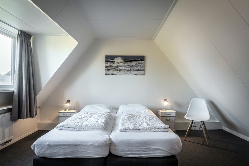 Bedroom with two beds in Holiday home De Heggemus, Den Burg, Texel with beach theme.