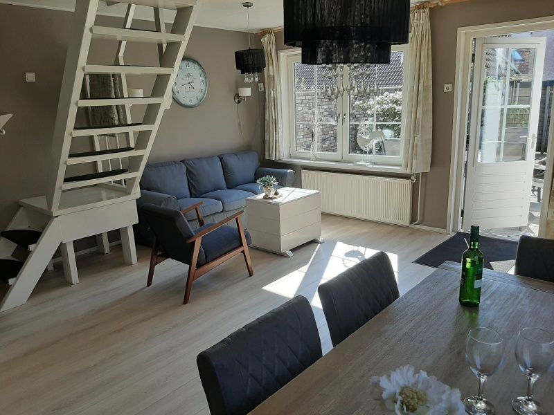 Bright living room with dining area in De Molen, vacation home in Den Burg, Texel.