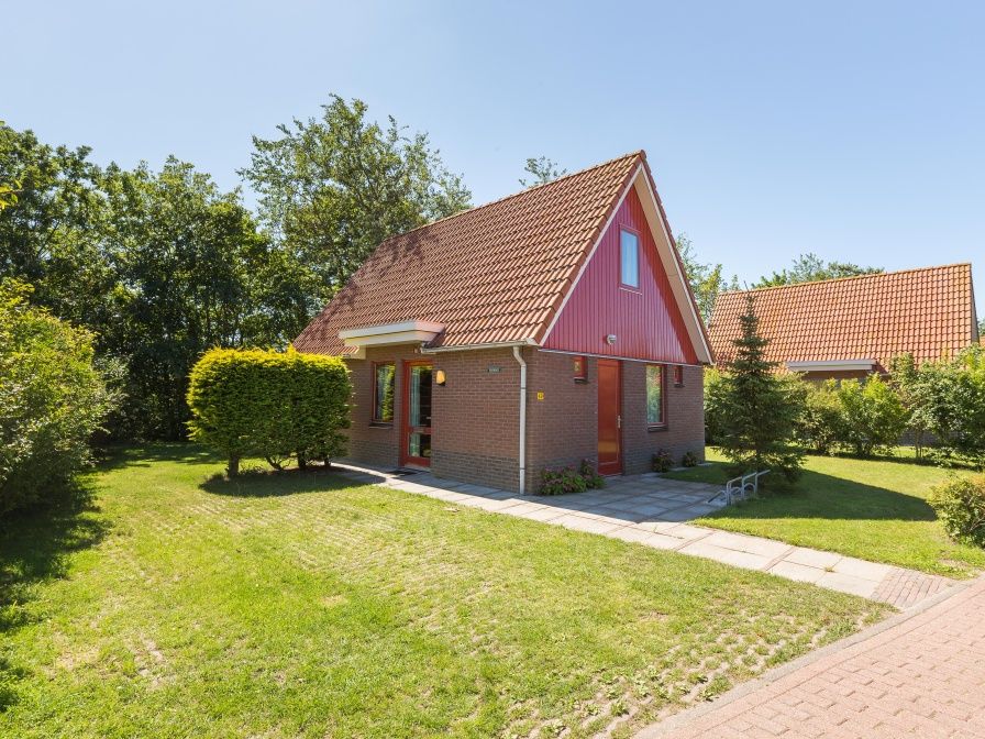 Type I - No. 49 Kragenmaker in Oosterend Texel, charming vacation home with red facade and green garden on the Wadden Islands.