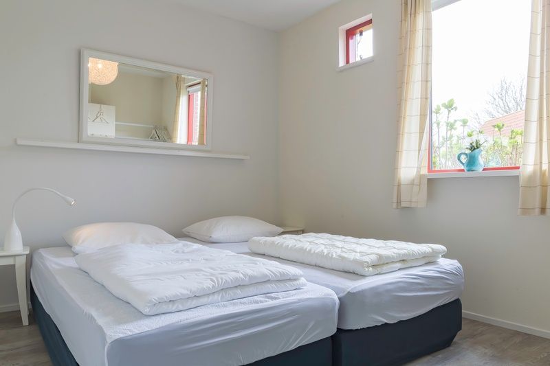 Helles Schlafzimmer in Typ II - Nr. 81 White Wagtail, Oosterend, Texel, mit zwei Betten und grossem Fenster.