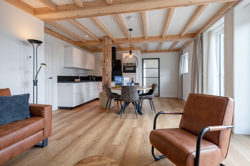 Open kitchen and dining area in Apartment C, Oudeschild, with modern amenities.