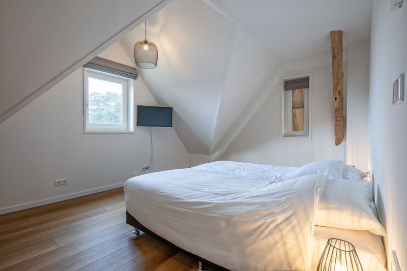 Comfortable bedroom in Apartment C, Texel, with double bed and skylights.