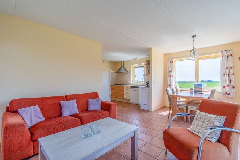 Spacious and bright living room of The Five Star Holiday Home in South Eierland Texel with modern furnishings.