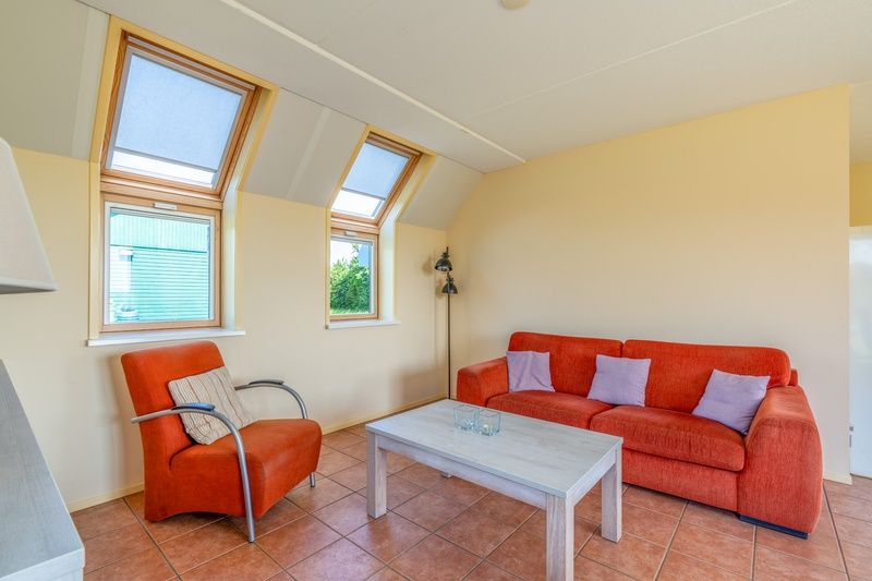 Comfortable sitting area in The Five Star Holiday Home South Eierland Texel overlooking the garden.