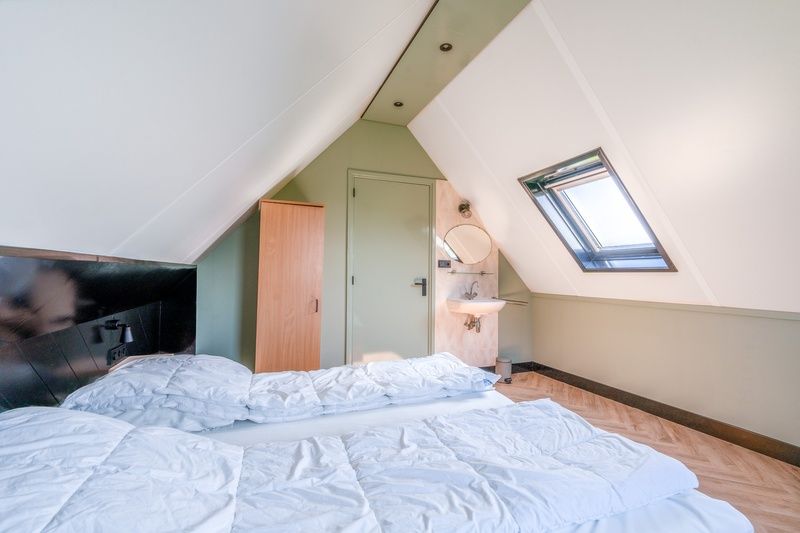 Cozy bedroom in The Five Star Holiday Home South Eierland Texel with comfortable beds.