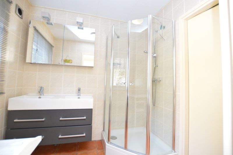 Stijlvolle badkamer in Vakantiehuis De Nagtegaal 15, De Wulk, De Dennen, Texel met moderne douche.