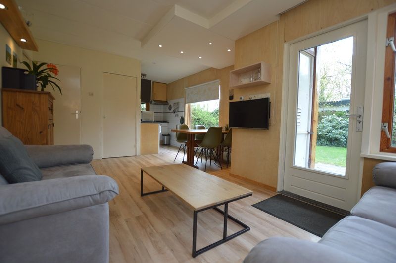 Open leefruimte in Vakantiehuis De Nagtegaal 19, De Dennen Texel met toegang tot terras.