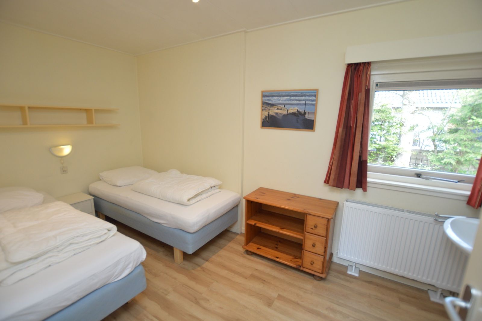 Slaapkamer met twee eenpersoonsbedden in Vakantiehuis De Nagtegaal 19, De Dennen Texel.