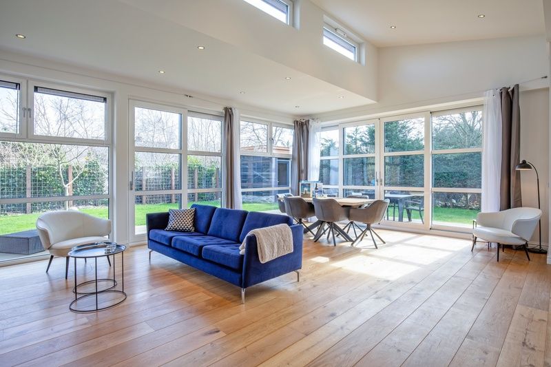 Stylish living room in Holiday Home De Vlinder, Texel, with large windows and an inviting atmosphere.