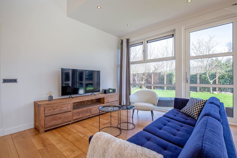 Cozy sitting area in Holiday Home De Vlinder, Texel, with garden views and modern facilities.