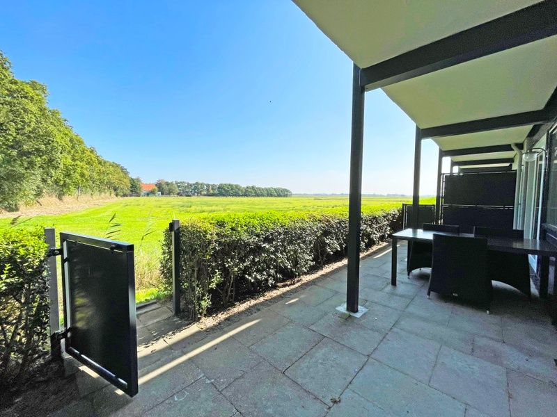 Schoene Aussicht von der Terrasse des Appartements Bos en Duin 14, De Dennen, Texel, ueber die weiten Felder.