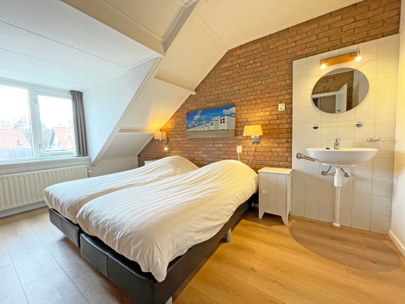 Attractive bedroom with double bed in Apartment Bos en Duin 34, Texel.