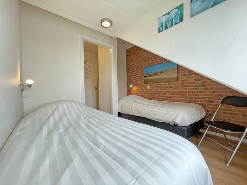 Cozy bedroom with two single beds in Apartment Bos en Duin 34, De Dennen, Texel.