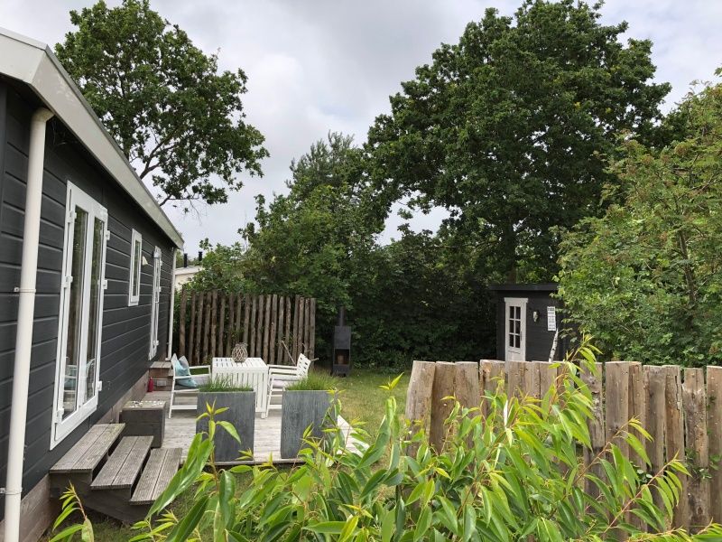 Relax on the terrace of Holiday Park de Bremakker - Chalet on Texel, Weideveld 80, surrounded by nature in De Dennen, Wadden Islands.