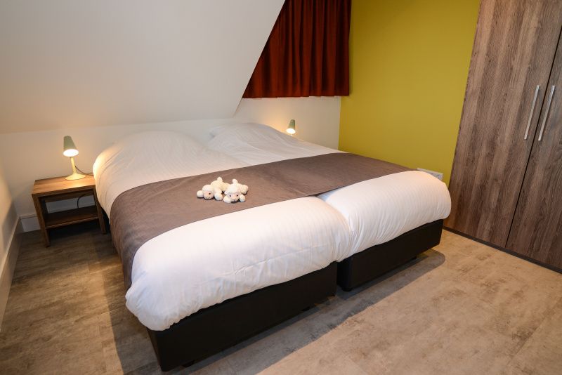 Komfortables Schlafzimmer im Bungalowpark 't Hoogelandt - De Zandkes, De Dennen, Texel mit gemuetlicher Einrichtung und stilvollen Details.