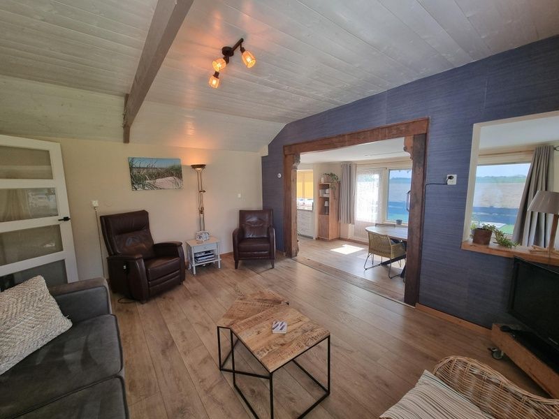 Interior of Weidezicht vacation home in De Dennen, Texel with open living room and dining room.