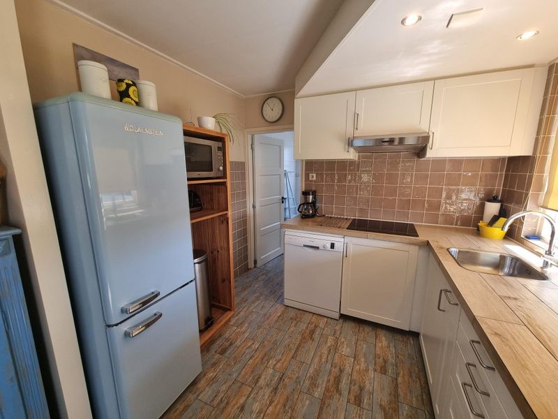 Modern kitchen in Weidezicht vacation home, De Dennen, Texel with retro fridge.