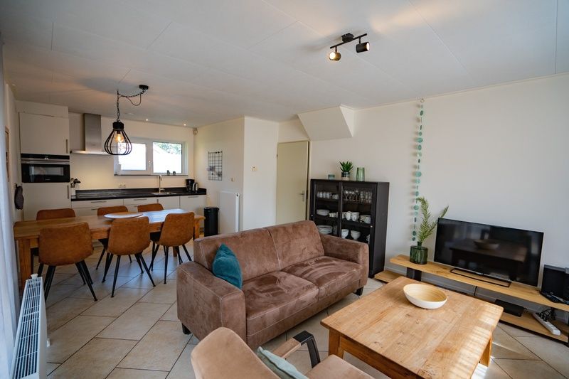 Cozy living room of Holiday Home 't Hoogelandt 136A in De Dennen, Texel with modern furnishings.