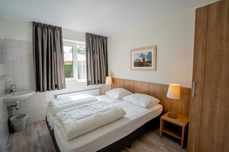 Comfortable bedroom in Holiday home 't Hoogelandt 136A, De Dennen, Texel with double bed.