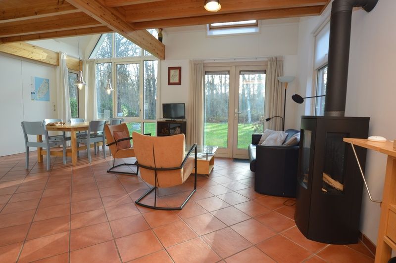 Modernes Wohnzimmer des Ferienhauses Monnikenweg 11 in De Dennen, Texel mit grossen Fenstern.