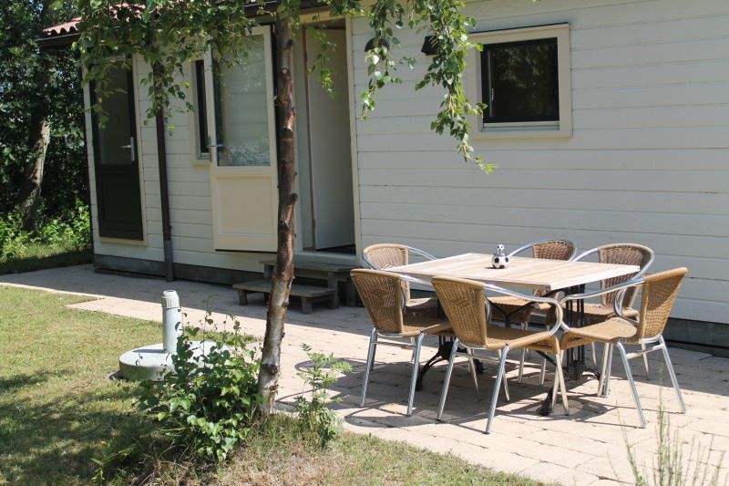 Geniet van de rust op het terras van Vakantiepark de Bremakker - Heitje 166, een vakantiehuis in De Dennen, Texel, omringd door natuur.