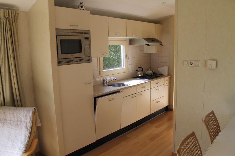 Moderne keuken en gezellige woonkamer in vakantiehuis Vakantiepark de Bremakker, Heitje 166, De Dennen, Texel, omgeven door natuur.