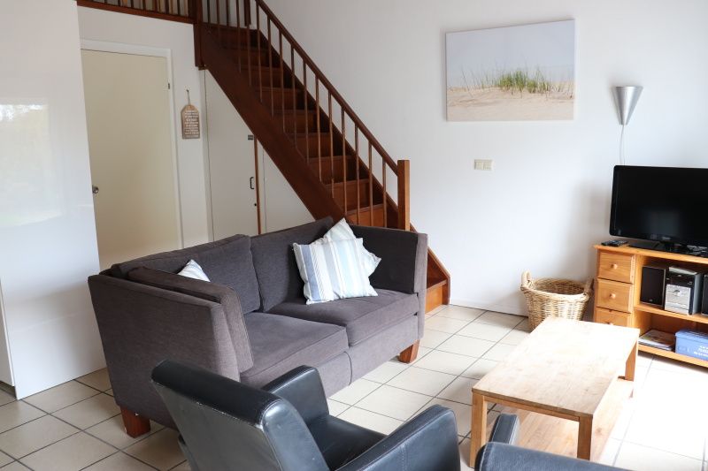 Sitting area with television in Holiday home Gortersmient 290, De Dennen, Texel.