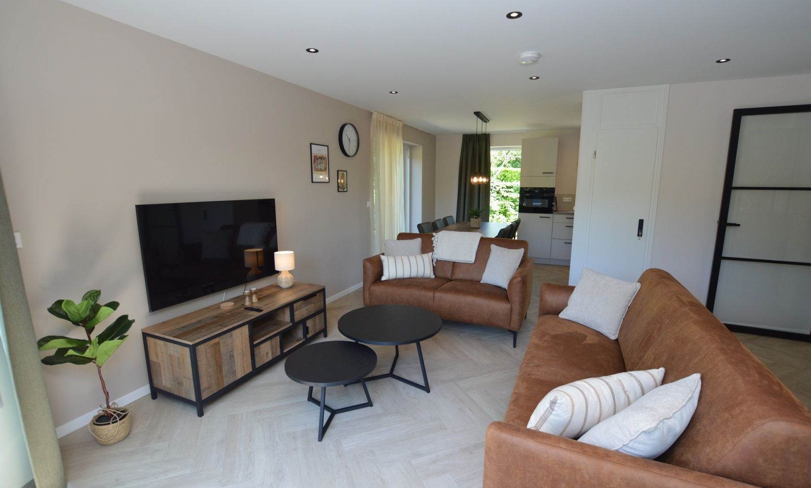 Stilvolles Wohnzimmer und Essbereich im Bungalow 't Hoogelandt 58, Texel, mit modernen Moebeln.