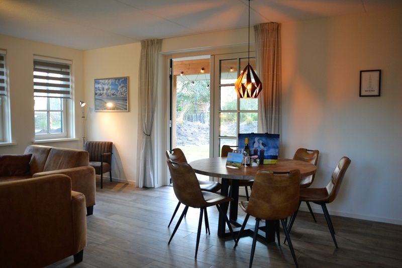 Spacious living room with access to veranda in Golden Raand, Texel.