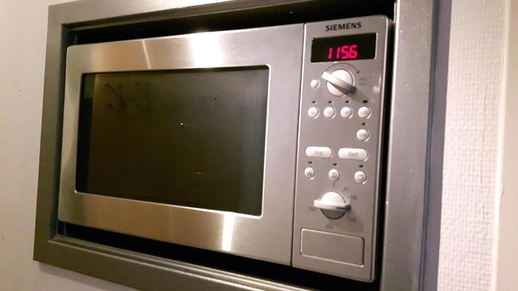 Ingebouwde magnetron in Appartement HELIOS - Amelander Kaap met ZWEMBAD, Hollum, Ameland, voor snelle en gemakkelijke maaltijden.