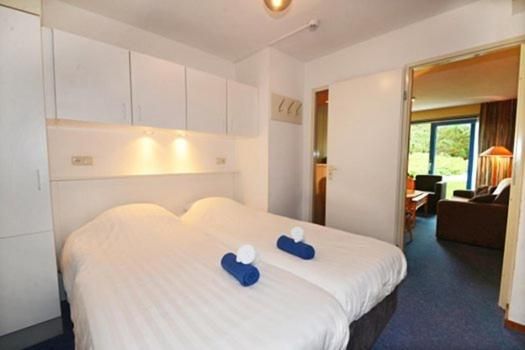 Comfortable bedroom in Apartment Amelander-Kaap TIME-OUT with SWIMMING POOL, Hollum, Ameland, ideal for a relaxing stay.