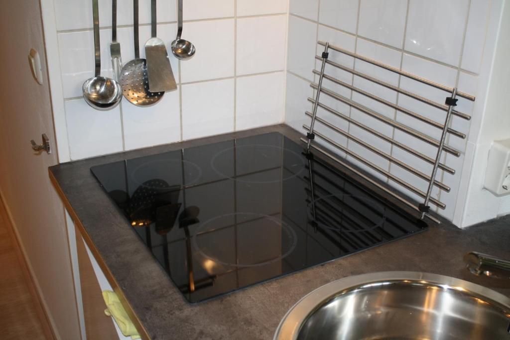 Modern kitchen in Apartment Amelander-Kaap TIME-OUT with SWIMMING POOL, Hollum, Ameland, with induction cooktop and convenient amenities.