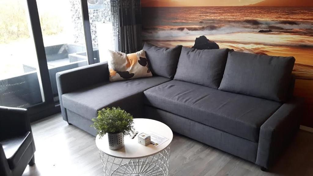 Modern seating area in Apartment Amelander-Kaap TIME-OUT with SWIMMING POOL, Hollum, Ameland, overlooking nature.