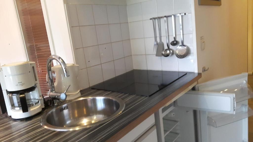 Fully equipped kitchen in Apartment Amelander-Kaap TIME-OUT with SWIMMING POOL, Hollum, Ameland, with modern appliances.