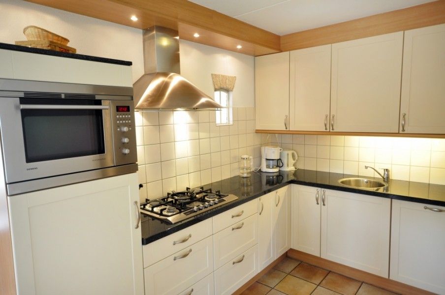 Moderne keuken in Appartementenboerderij de Hek Oost, Hoorn, Terschelling met inbouwapparatuur.