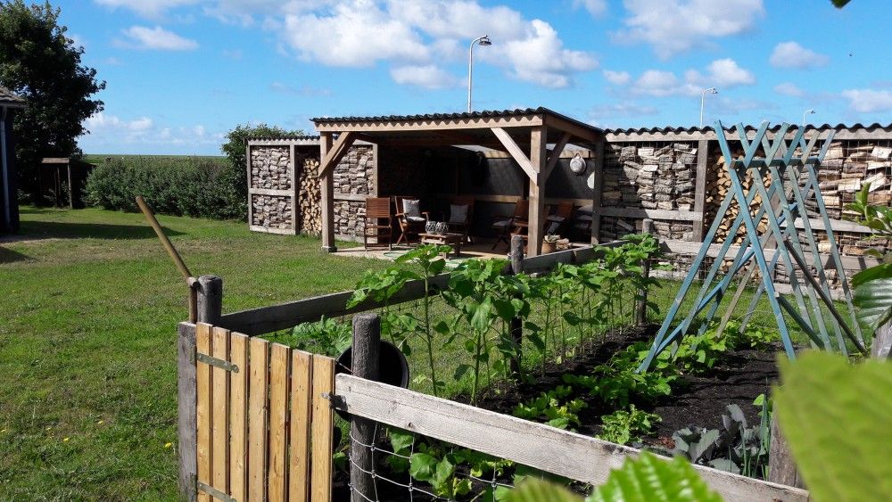 Tuin met overdekte zithoek bij Appartementenboerderij de Hek Oost, Hoorn, Terschelling.