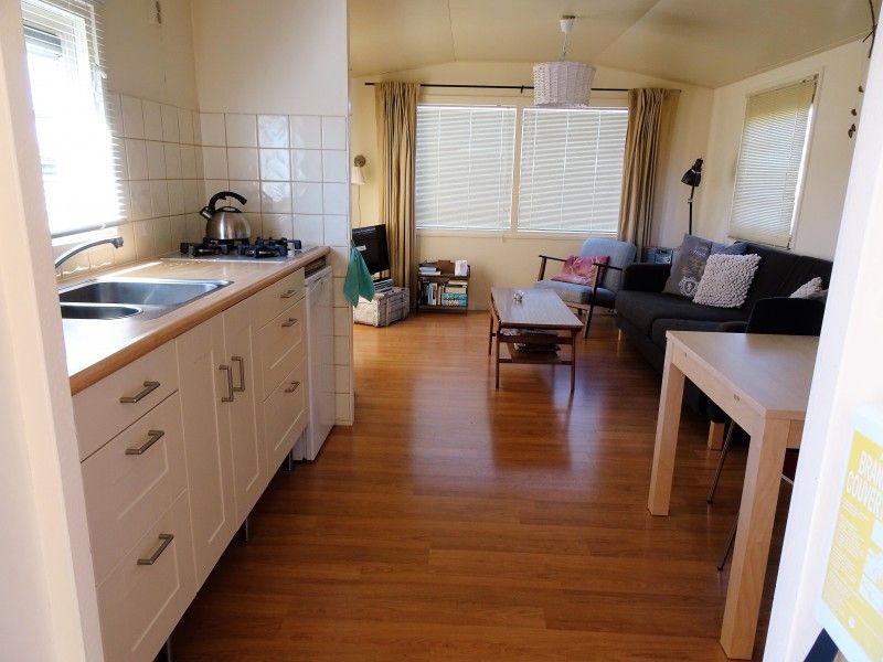 Open kitchen and living room in De Doorloper chalet, Midsland Noord, Terschelling on the Wadden Islands.