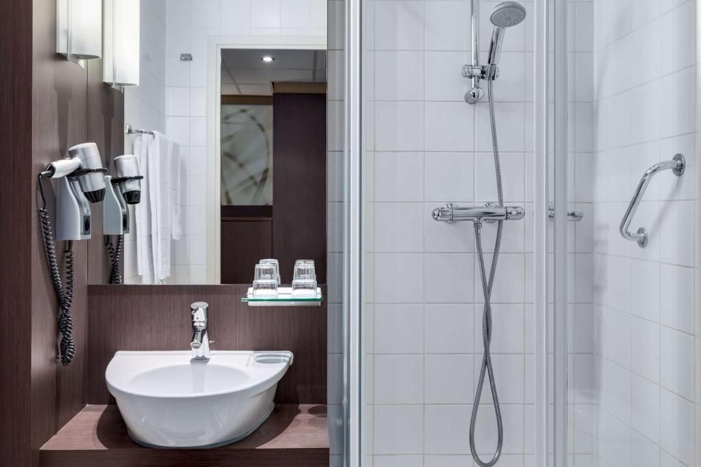 Moderne badkamer met douche in NH Centre Utrecht Hotel, Utrecht, voor een verfrissende ervaring.