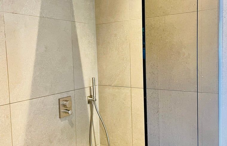 Die luxurioese Dusche im Ferienhaus in Ballum, Ameland, bietet ein erfrischendes Erlebnis nach einem Tag voller Entdeckungen.